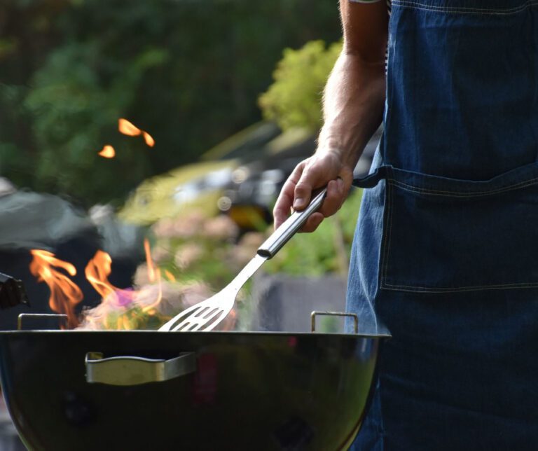 person using an outdoor grill